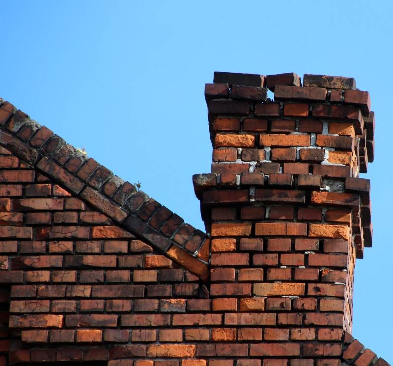 Signs Your Revere Home Needs a Chimney Inspection Damaged chimney on an Revere home showing cracks and missing mortar